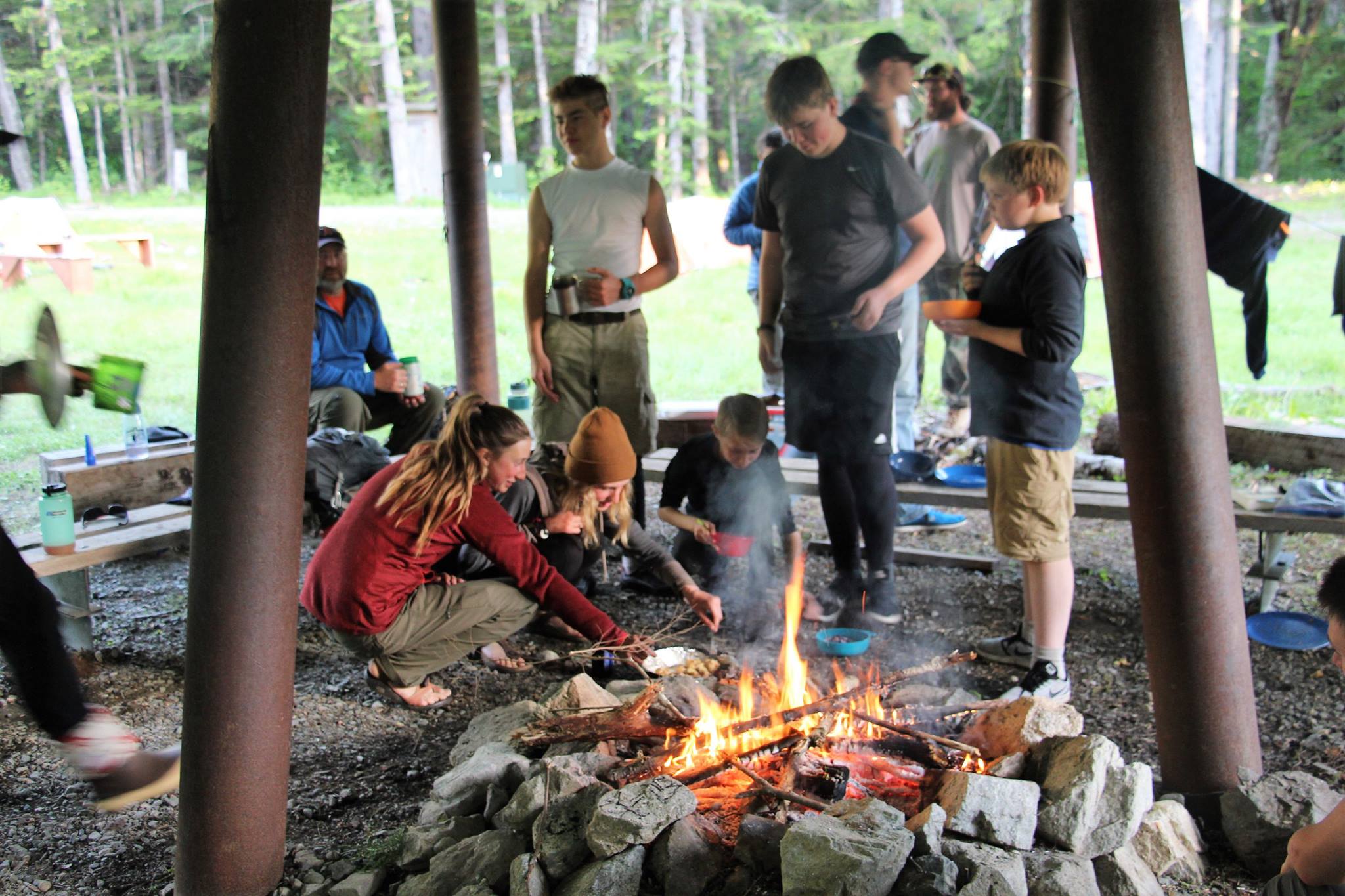 Scouts enjoy roasting smores on the adventure base's covered firepit